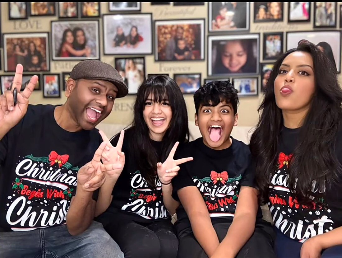 Jessica and her family smiling together at home