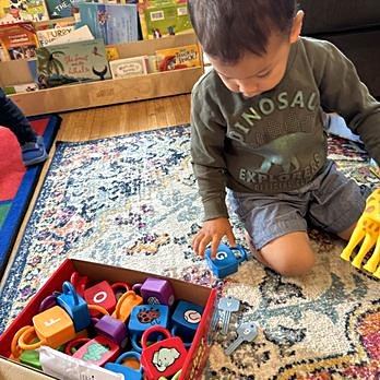 Toddler exploring alphabet blocks