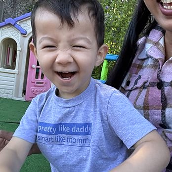 Toddler laughing in the play yard