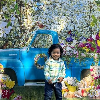 Girl at spring picture day with flower truck backdrop