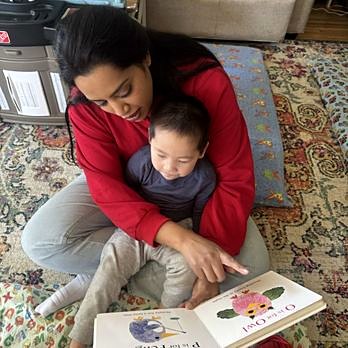 Teacher reading a picture book with a child